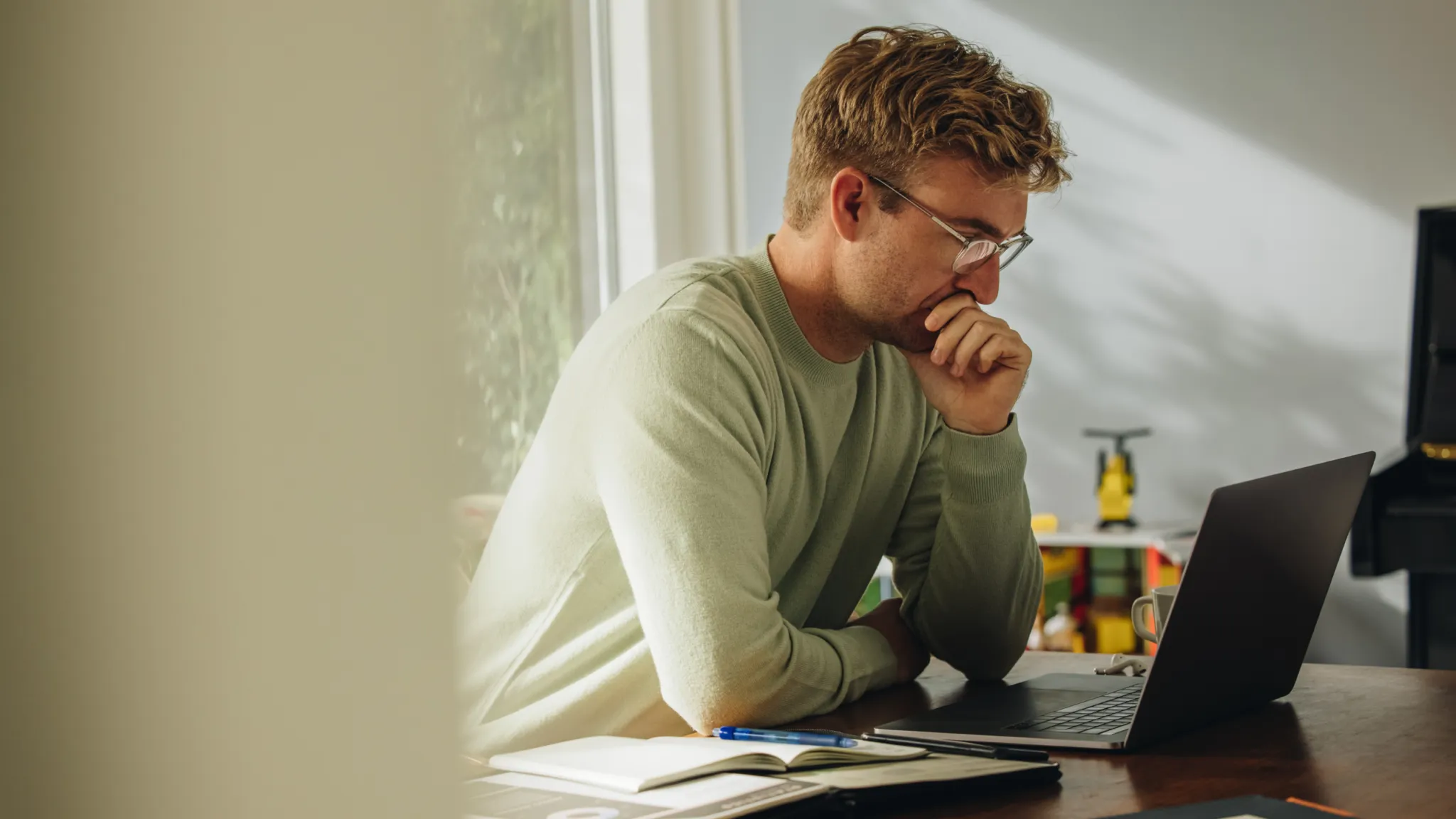 A person reading intently at a laptop