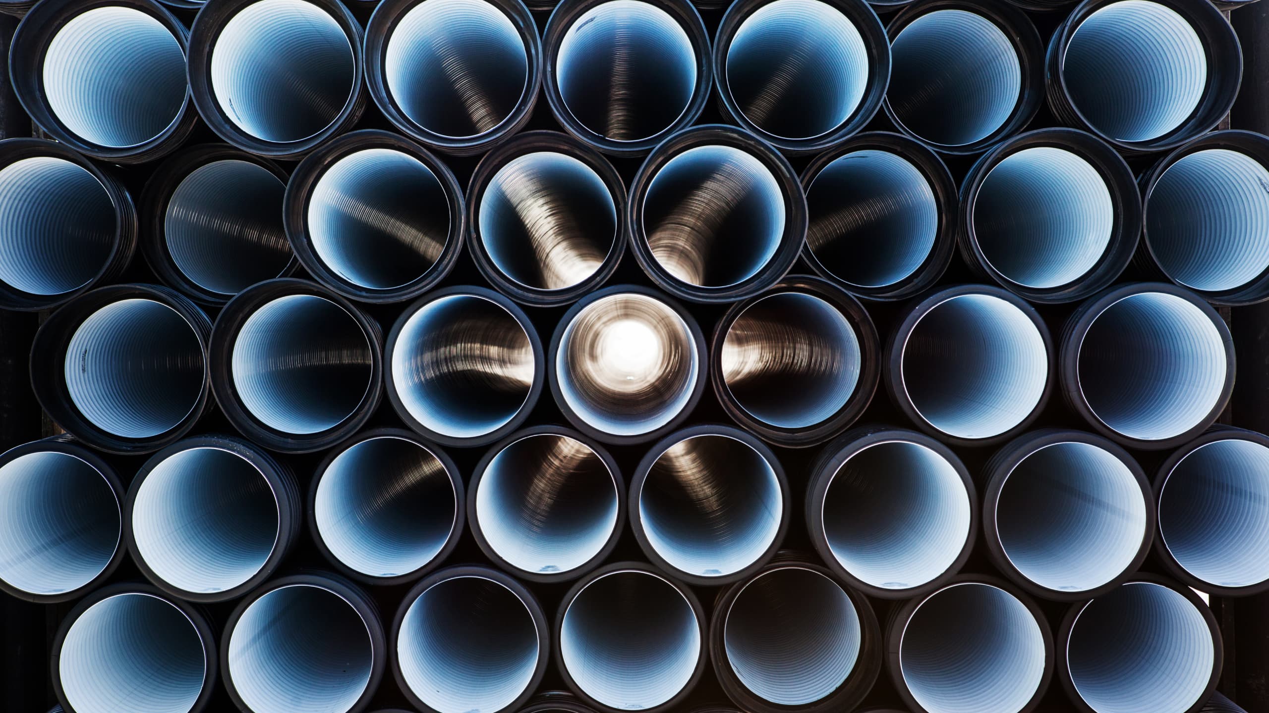 A stack of plastic pipes for use in infrastructure projects.